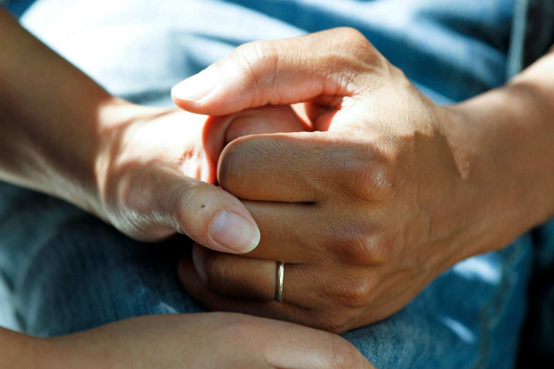 Two people holding hands in a supportive gesture